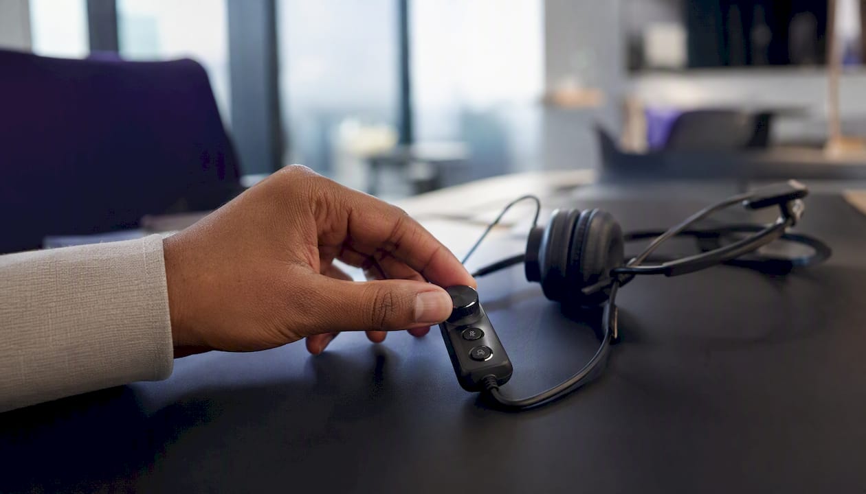 Hand operating sales call headset button