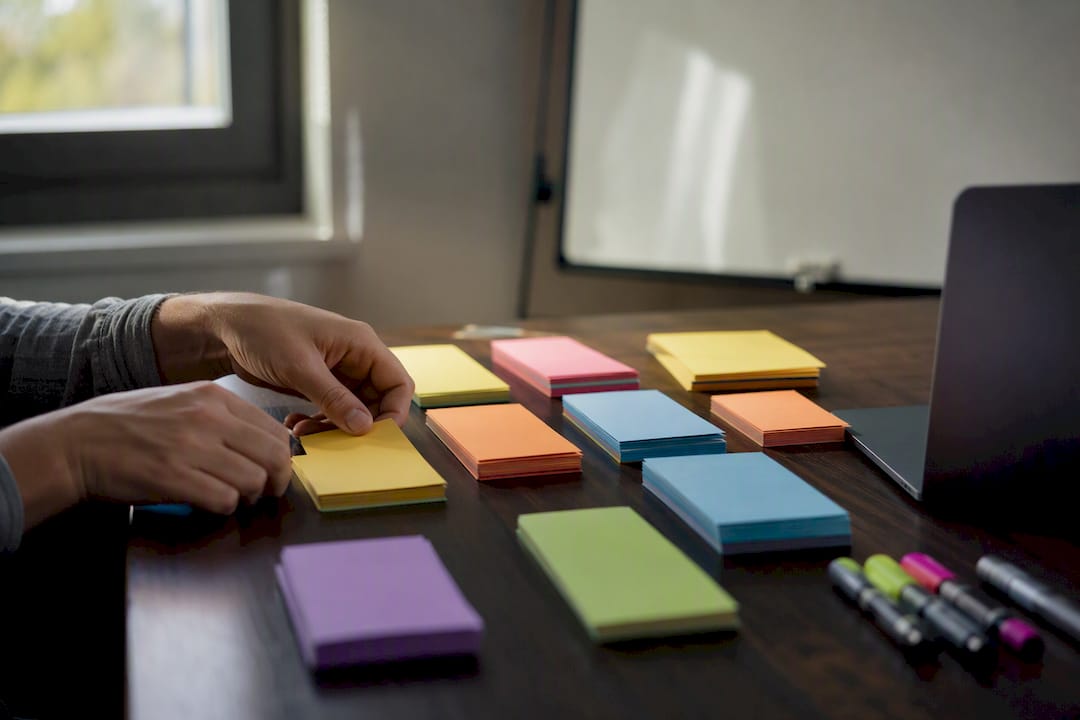 Hands sorting sales discovery question cards